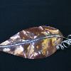 Copper and silver leaf pin.  Formed using repousse technique.  This is part of a matching pin and earring set.  $195