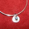 Fine silver bangle bracelet with disk charm.  Charm has 4 prong setting for 4 mm birthstone.  Back of disk has a stampedinitial. SOLD:  $135.00